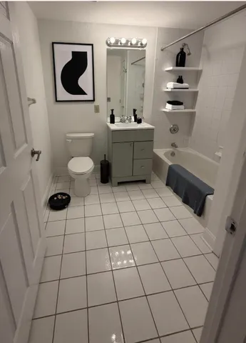 a bathroom with a sink toilet and mirror