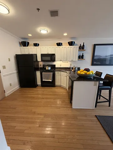 a kitchen with stainless steel appliances granite countertop a refrigerator and a stove