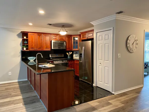 a kitchen with stainless steel appliances granite countertop a stove and a refrigerator