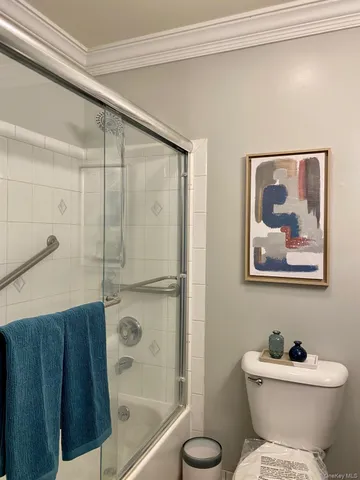 a bathroom with a toilet sink and shower