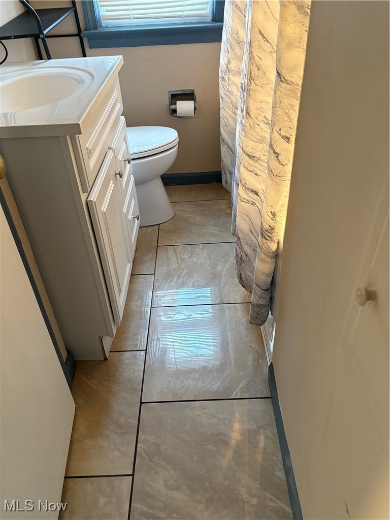 17914 Libby Road Maple Heights, OH 44137 - Photo 11 of 17 Full bath featuring light marble finish flooring, vanity, and a shower with curtain