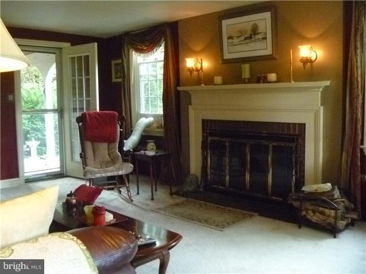 100 East Springfield Road Springfield, PA 19064 - Photo 5 of 21 a living room with furniture and a fireplace