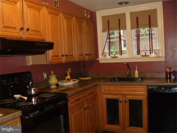 100 East Springfield Road Springfield, PA 19064 - Photo 10 of 21 a kitchen with stainless steel appliances granite countertop a stove a sink and a microwave