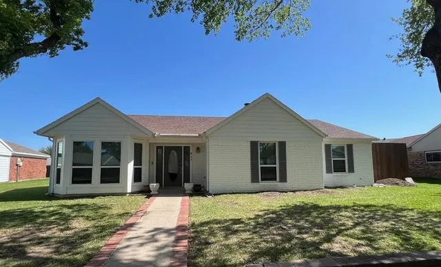 a front view of a house with a yard and porch