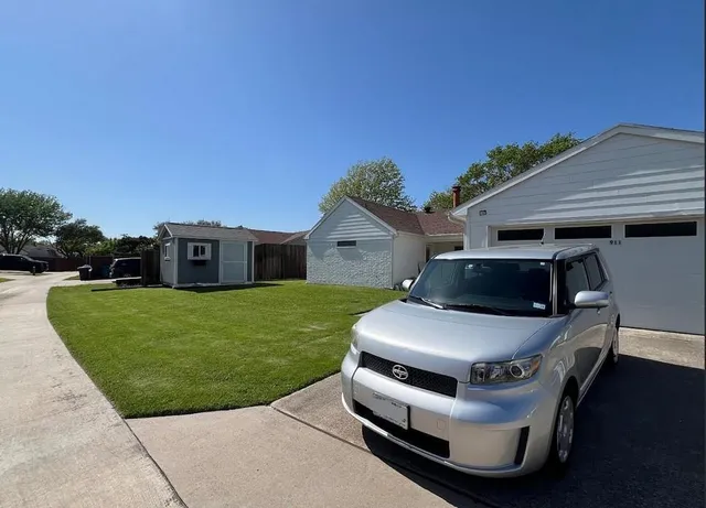 a view of a house with a yard and sitting area