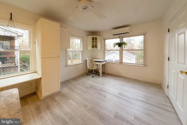a big room with wooden floor and windows