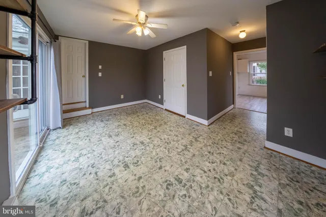 en empty room with a empty space and chandelier fan