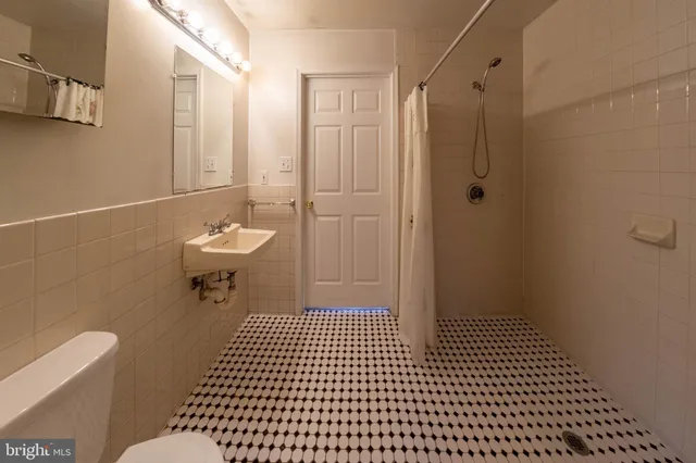 a bathroom with a toilet a sink and shower