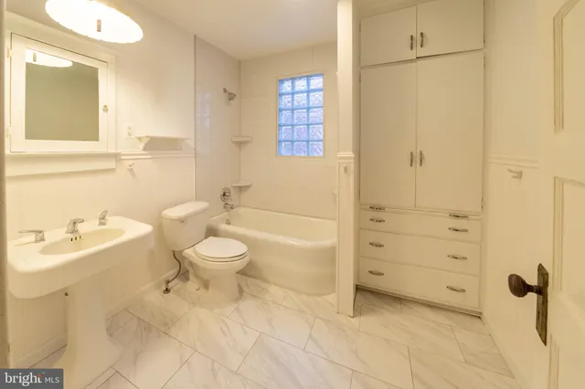 a bathroom with a toilet sink and shower