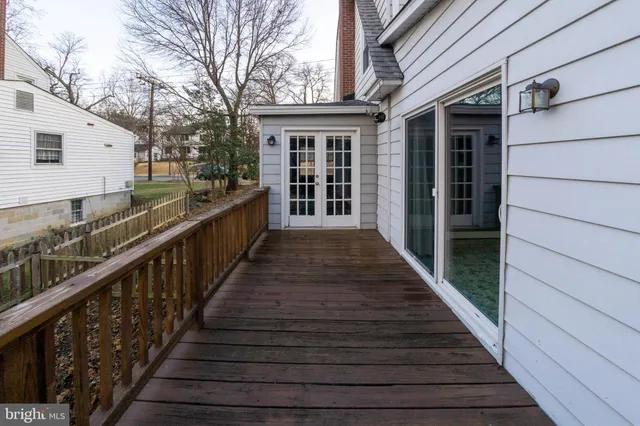 a view of a roof deck with wooden floor and fence