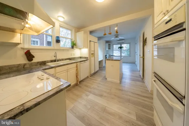 a large kitchen with stainless steel appliances granite countertop a large counter top and a stove