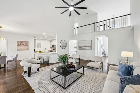 a kitchen with a sink a stove a refrigerator cabinets and wooden floor