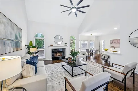 a living room with furniture a clock and a fireplace