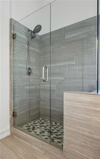 a bathroom with a sink mirror and shower