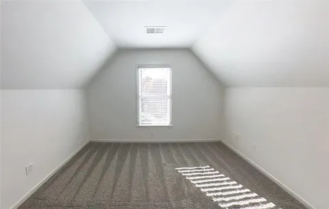 a view of a big room with wooden cabinet and a kitchen