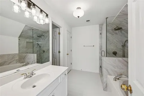 a large open kitchen with stainless steel appliances granite countertop a stove top oven a sink dishwasher a dining table and chairs with wooden floor