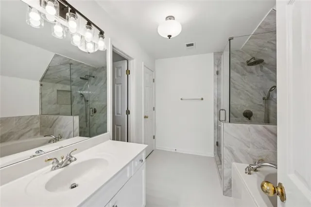 a large open kitchen with stainless steel appliances granite countertop a stove top oven a sink dishwasher a dining table and chairs with wooden floor