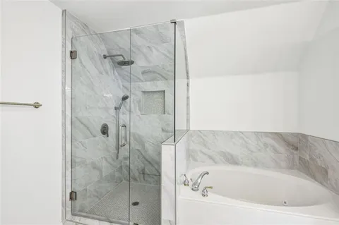 a kitchen with granite countertop stainless steel appliances cabinets a sink and a wooden floor