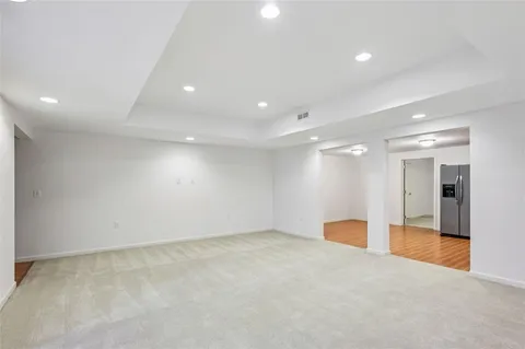 a kitchen with a refrigerator stove and wooden cabinets