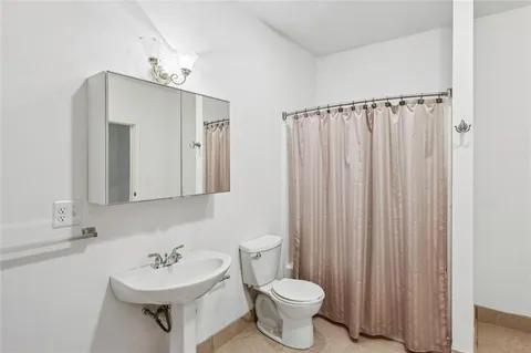 a view of a porch with wooden floor and fence