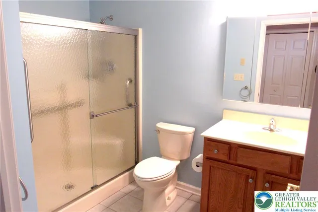 a bathroom with a toilet a sink and a shower