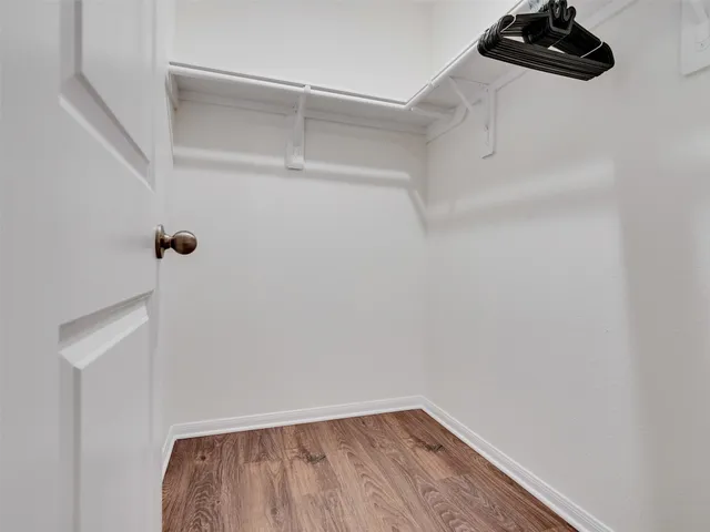 a bedroom with a bed and a night stand