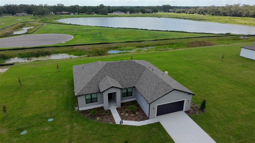 2330 Hiers Road Dover, FL 33527 - Photo 1 of 1 an aerial view of a house with a garden and lake view