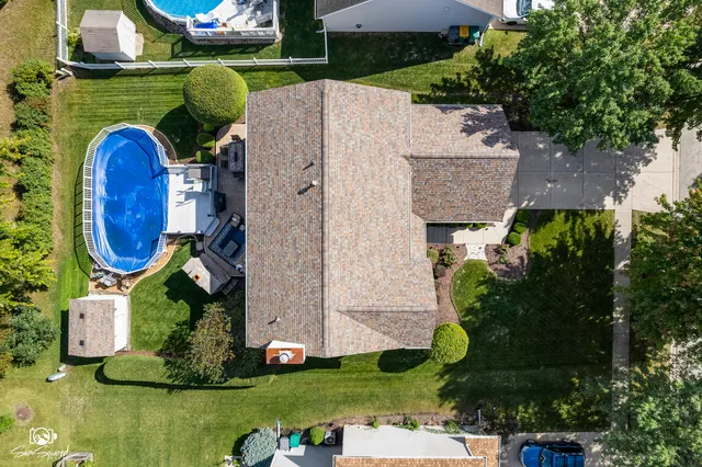an aerial view of a house with a garden and trees