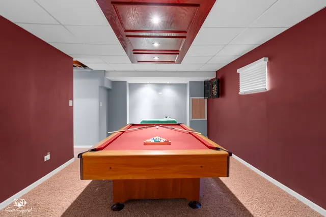 a view of a room with furniture and a flat screen tv