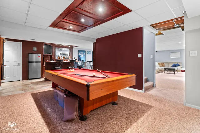 a living room with furniture and a gym machine