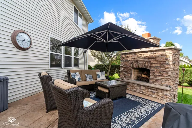 a balcony with furniture and a fireplace