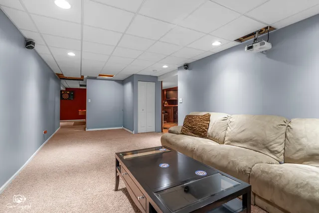 a view of a deck with couches chairs and a table with garden view