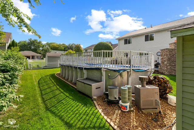 an aerial view of house with yard swimming pool and outdoor seating