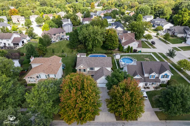 an aerial view of a houses with a yard