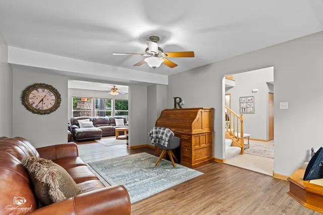 a living room with furniture a couch and a chandelier