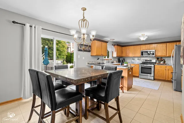 a view of a dining room with furniture a chandelier and wooden floor