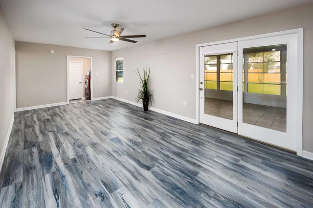 wooden floor in an empty room with a window