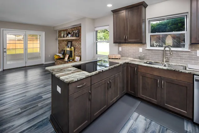 a kitchen with a sink stove and cabinets
