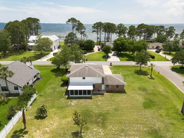 a aerial view of a house with swimming pool garden and mountain view