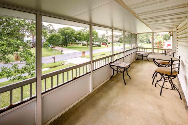 a bathroom with a granite countertop sink toilet mirror and bathtub