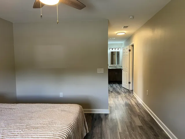a bathroom with a granite countertop shower sink and mirror