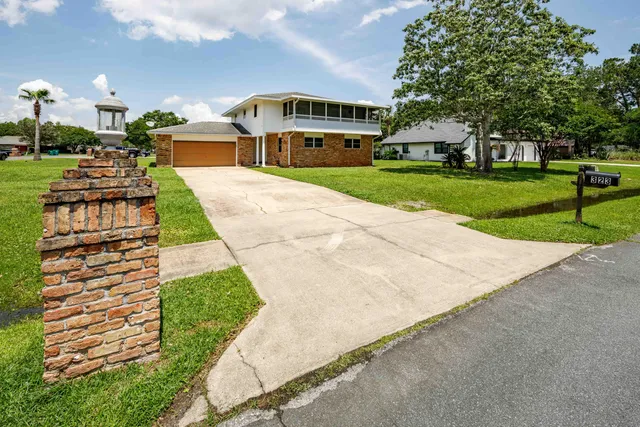 a aerial view of a house with a garden and yard