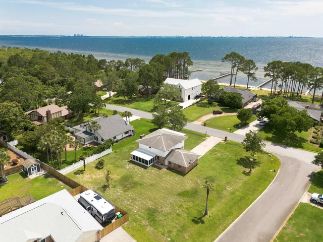a aerial view of a house with a yard table and chairs