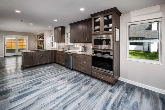 a kitchen with stainless steel appliances granite countertop a stove and a refrigerator