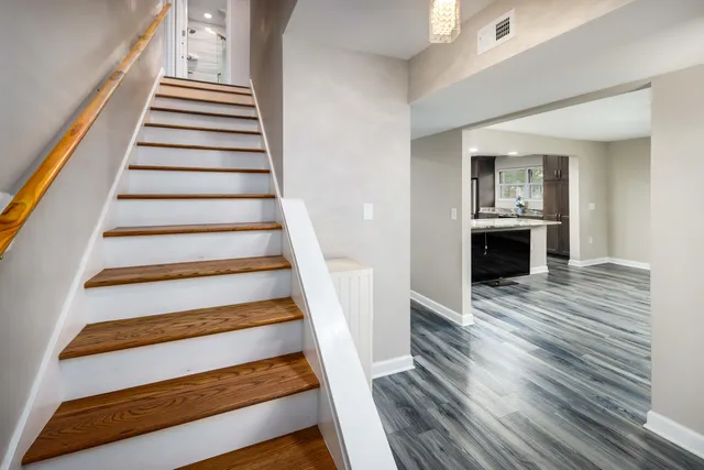 a view of entryway and hall with wooden floor