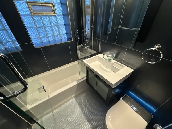 a bathroom with a sink a toilet and shower