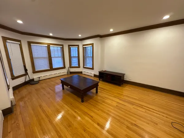 a room with wooden floor and furniture