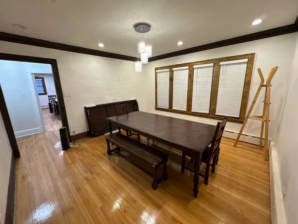a view of a room with furniture and wooden floor