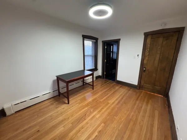 a room with wooden floor and furniture
