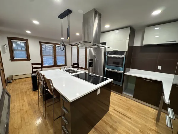 a large kitchen with a table chairs refrigerator and microwave